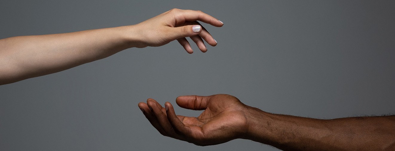 Two hands reaching for each other