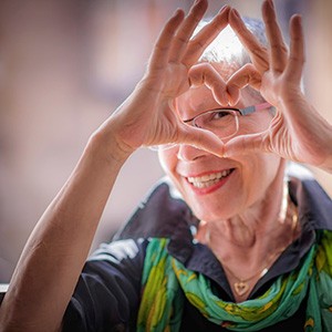 Senior woman making heart shape with her hands