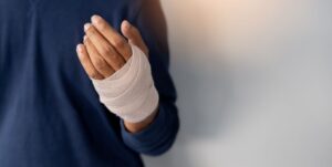 Person’s hand wrapped in bandage after hand surgery