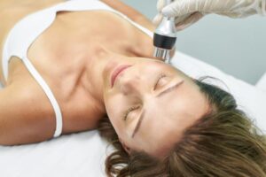 Woman undergoing laser skin treatment